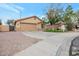 House exterior featuring a two-car garage and well-maintained landscaping at 14727 N Gil Balcome N Ct, Surprise, AZ 85379
