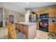 Bright kitchen featuring an island, stainless steel appliances, and light wood cabinets at 14727 N Gil Balcome N Ct, Surprise, AZ 85379