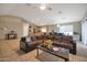 Living room with a brown sectional sofa and a large flat-screen TV at 14727 N Gil Balcome N Ct, Surprise, AZ 85379