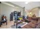 Living area featuring a sectional sofa, a large TV, and a ceiling fan at 14727 N Gil Balcome N Ct, Surprise, AZ 85379