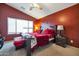 Large bedroom with a king-size bed, red bedding and a walk-in closet at 14727 N Gil Balcome N Ct, Surprise, AZ 85379