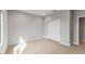 Neutral bedroom features a window, carpet floors, and white closet at 2851 N Coronado Dr, Florence, AZ 85132