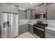 Gray cabinets and stainless steel appliances including refrigerator, gas range and microwave at 2851 N Coronado Dr, Florence, AZ 85132