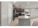 Open kitchen with gray cabinets, stainless appliances, granite countertops, and tile flooring at 2851 N Coronado Dr, Florence, AZ 85132