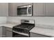 Close up view of the kitchen's stainless microwave, gas range and granite countertops at 2851 N Coronado Dr, Florence, AZ 85132