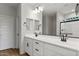 Modern bathroom featuring double sink vanity, black hardware, and a glass enclosed shower at 2868 N Coronado Dr, Florence, AZ 85132