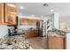 Beautiful kitchen with granite countertops, stainless steel appliances, and wooden cabinetry at 31777 N Sundown Dr, San Tan Valley, AZ 85143