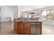Kitchen sink and dishwasher with granite countertops and view to backyard playset at 31777 N Sundown Dr, San Tan Valley, AZ 85143