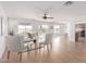 Bright, open living room with a ceiling fan, neutral tones, and sliding glass doors to the back yard at 31777 N Sundown Dr, San Tan Valley, AZ 85143