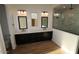 Modern bathroom with double sink vanity, quartz countertop, and glass-enclosed tiled shower at 32535 N 135Th Dr, Peoria, AZ 85383