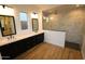 Contemporary bathroom featuring double sink vanity, quartz countertops, and a tiled shower at 32535 N 135Th Dr, Peoria, AZ 85383