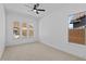 Bedroom featuring neutral walls, carpet flooring, and multiple windows for natural light at 32535 N 135Th Dr, Peoria, AZ 85383