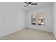 Bright bedroom with neutral walls, carpet flooring and windows offering views of the surroundings at 32535 N 135Th Dr, Peoria, AZ 85383
