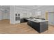 Bright, open kitchen with modern appliances, a large island, and ample counter space, ideal for culinary creations and socializing at 32535 N 135Th Dr, Peoria, AZ 85383