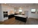 Bright kitchen features white cabinets, stainless appliances, and an island with a white countertop at 32535 N 135Th Dr, Peoria, AZ 85383