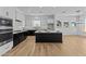 Modern kitchen with stainless steel appliances, a black island, and white cabinetry, perfect for culinary enthusiasts and entertaining at 32535 N 135Th Dr, Peoria, AZ 85383