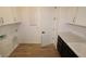 Laundry room features white cabinets and granite countertop, providing ample storage and workspace at 32535 N 135Th Dr, Peoria, AZ 85383