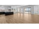 Bright, open-concept living area with wood-look tile flooring and an abundance of natural light, seamlessly connects indoor and outdoor spaces at 32535 N 135Th Dr, Peoria, AZ 85383