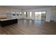 Living space with wood-look tile flooring, and kitchen with an island that has a white countertop at 32535 N 135Th Dr, Peoria, AZ 85383