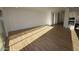 Large living room space featuring wood-look tile flooring and view into kitchen area at 32535 N 135Th Dr, Peoria, AZ 85383