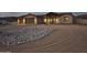Inviting single-story home with a circular driveway and desert landscaping, presenting a serene curb appeal at 48515 N 13Th Ave, New River, AZ 85087