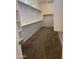 Walk-in closet with carpet flooring and built-in shelving for ample storage space at 10005 W Spur Dr, Peoria, AZ 85383