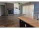 Inviting living room featuring a fireplace and tile flooring with a view of the kitchen island at 10005 W Spur Dr, Peoria, AZ 85383