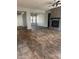 Open-concept living room featuring a brick fireplace and wood-look tile flooring throughout at 10005 W Spur Dr, Peoria, AZ 85383