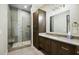Modern bathroom with walk-in shower and dark brown vanity at 8742 E Woodley Way, Scottsdale, AZ 85266