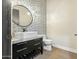 Stylish powder room with patterned wall and modern vanity at 8742 E Woodley Way, Scottsdale, AZ 85266