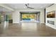 Open and airy living room with hardwood floors, a fireplace, and access to a beautiful pool area at 8742 E Woodley Way, Scottsdale, AZ 85266
