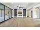 Bright living room with hardwood floors, fireplace, and sliding glass doors leading to the backyard at 8742 E Woodley Way, Scottsdale, AZ 85266