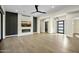 Open living area featuring hardwood floors, a modern fireplace, and access to outdoor space at 8742 E Woodley Way, Scottsdale, AZ 85266