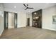 Spacious living room with hardwood floors, fireplace, and modern sliding barn doors at 8742 E Woodley Way, Scottsdale, AZ 85266