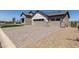 Exterior view showcasing a multi-car garage, mixed stone and siding facade, and manicured landscaping at 1606 E Minton St, Mesa, AZ 85203