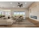 Bright living room featuring modern fireplace, hardwood floors, neutral colors, and a ceiling fan at 1606 E Minton St, Mesa, AZ 85203