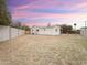 Backyard with brick fence and white home at sunset at 634 S Pasadena --, Mesa, AZ 85210