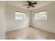 Vacant bedroom with two windows, tile flooring and a ceiling fan at 634 S Pasadena --, Mesa, AZ 85210