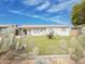 Quaint home featuring a tidy front lawn, desert plants, and a covered carport at 634 S Pasadena --, Mesa, AZ 85210