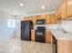 Efficient kitchen featuring black appliances, wood cabinets, and tile flooring at 634 S Pasadena --, Mesa, AZ 85210