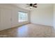 Open living room with tile flooring, a bright window, and a ceiling fan for added comfort at 634 S Pasadena --, Mesa, AZ 85210
