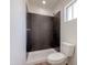 Modern bathroom with tile shower, white toilet, and neutral accents at 634 S Pasadena --, Mesa, AZ 85210