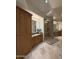 Well-lit bathroom featuring a spacious shower, granite countertops, and custom storage at 8 E Biltmore Est # 109, Phoenix, AZ 85016