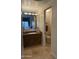 Bathroom featuring a granite vanity, ample lighting, and a view into the primary bedroom at 8 E Biltmore Est # 109, Phoenix, AZ 85016