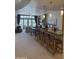 Open-concept living space with kitchen island, counter seating, and views of the living area at 8 E Biltmore Est # 109, Phoenix, AZ 85016
