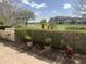 Beautifully landscaped yard with manicured hedges, flowers, and view to the golf course at 8 E Biltmore Est # 109, Phoenix, AZ 85016