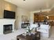 Cozy living room with fireplace and view into the kitchen and dining area at 8 E Biltmore Est # 109, Phoenix, AZ 85016