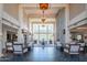 Expansive lobby with high ceilings, stone fireplace, comfortable seating and elegant lighting fixtures at 8 E Biltmore Est # 109, Phoenix, AZ 85016