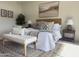 Comfortable bedroom with patterned rug, lamps, and bench seat at 8 E Biltmore Est # 109, Phoenix, AZ 85016