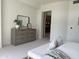 Spacious bedroom featuring dresser, large mirror, and view into the hallway at 8 E Biltmore Est # 109, Phoenix, AZ 85016